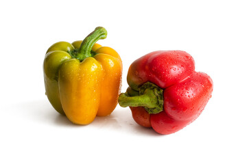 Two wet bell peppers, red and yellow, with water drops on the sides