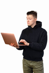 A young man in a black sweatshirt holds a laptop. The businessman is studying statistics in the computer. The man is surprised.