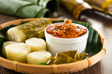 Glutinous rice is wrapped with lerek or banana leaf encased in bamboo culm and cooked in open fire / Lemang / A must have in every traditional Malay household, eaten with beef or chicken rendang