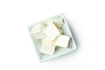 Bowl with feta cheese pieces isolated on white background