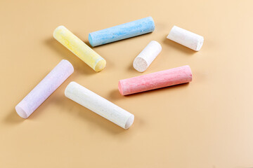 Colored crayons on a beige background. Child Game. Hobby. Child development and leisure concept. Copy space.