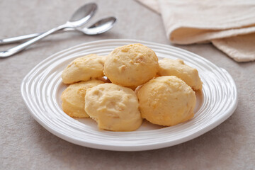 Butter cookies with almond on white plate.