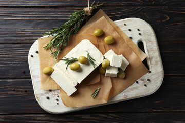 Concept of tasty food with feta cheese on wooden background
