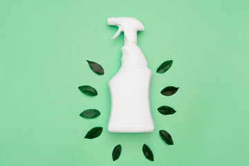 Ecological object. Eco-friendly, natural cleaning products concept. White bottle with a spray bottle and green leaves around on a green background. Eco general cleaning of the house. top view.Flat lay - Powered by Adobe