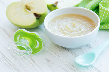 Bowl with fruit baby food and apples