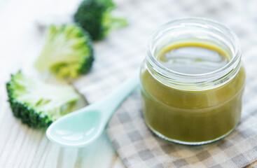 Baby food. Organic green broccoli  puree with ingredients.