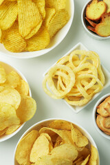 Bowls with different snacks on white background