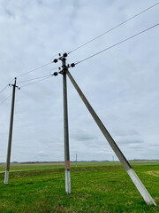 Poles with wires, electric wires on poles in the field