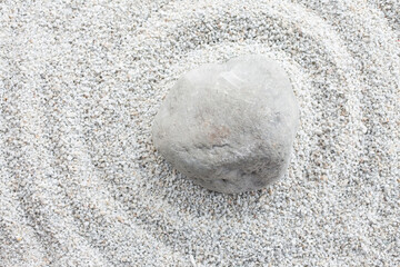 Stone on white sand