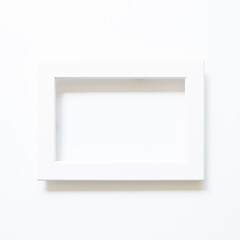 White picture frame on white background. top view, copy space