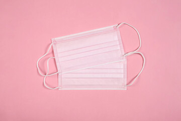 lesbian couple concept: two pink medical face masks with copy space for your text