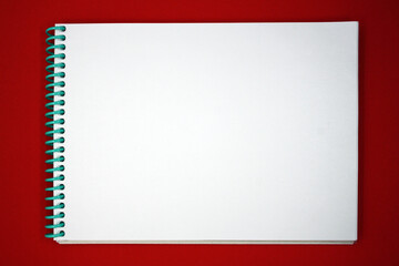 Notepad for notes and sketches on a red background.