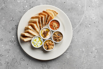 Mediterranean snack set. Hummus, olives, peppers, yogurt, beans. Greek cuisine. Assorted. Place for text