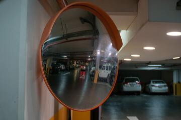 Curve mirror at a basement parking.Traffic mirror safety and security concept. Selective focus