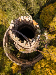 Abandoned lime kiln tower in sunny autumn day, Latvia.