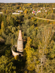 Abandoned lime kiln tower in sunny autumn day, Latvia.
