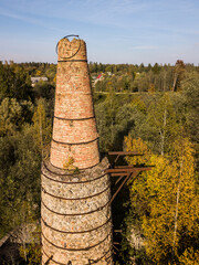 Abandoned lime kiln tower in sunny autumn day, Latvia.