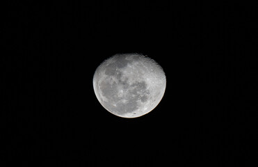 Half Moon over dark black sky at night. Selective focus