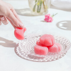 Mochi pink japanese sweets on a white table
