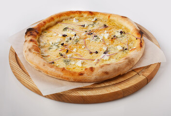 Top view of hot pizza on a wooden stand.