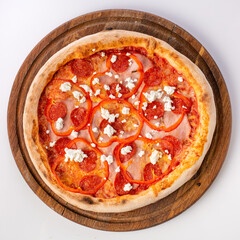 Top view of hot pizza on a wooden stand.