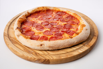 Top view of hot pizza on a wooden stand.