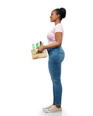 recycling, waste sorting and sustainability concept - happy smiling young african american woman holding wooden box with glass bottles over white background