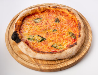 Top view of hot pizza on a wooden stand.