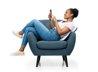comfort, people and furniture concept - portrait of happy smiling young african american woman with...