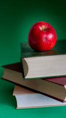 Red apple on three fat books