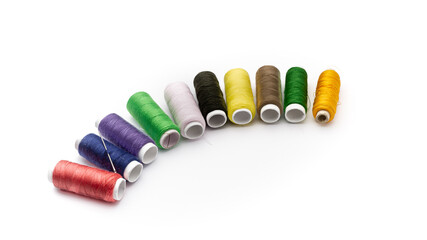 Thread in different colors on white background