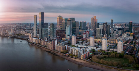 Panoramic view of the residential and commercial skyscrapers of Canary Wharf and the Docklands in London, United Kingdom, during sunset time