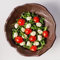 Caprese salad. Only fresh arugula, cherry tomatoes, juicy mini mozzarella and a dressing of oregano and olive oil