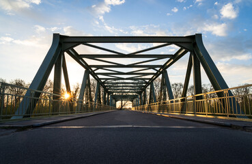 Empty bridge over a railroad during a spring sunrise.
