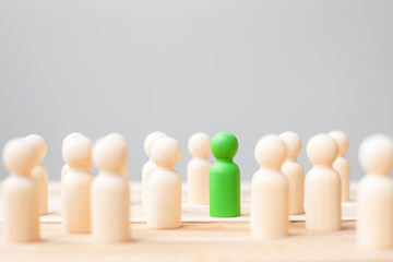 Green leader business man with crowd of wooden people. leadership, business, team, teamwork and Human resource management concept
