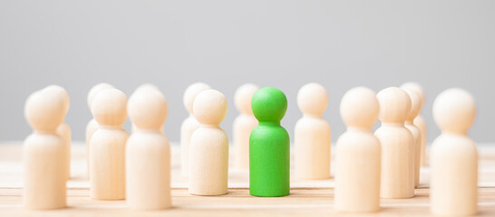 Green leader business man with crowd of wooden people. leadership, business, team, teamwork and...