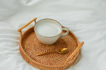 Obraz na płótnie Canvas Breakfast in bed, cappuccino, wicker tray, spring, home decor. Cozy.