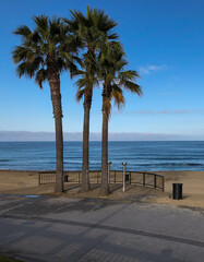 Beautiful Californian sandy beach with wake of Pacific Ocean on West Coast with volleyball fields,...