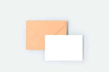 Envelope and empty paper sheet mockup. Letter template on a blue background.