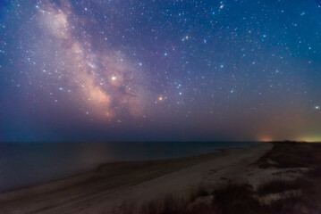 Starry sky over sea coast