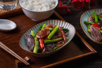 Delicious spicy homemade stir-fried Chinese smoked sausage with asparagus.