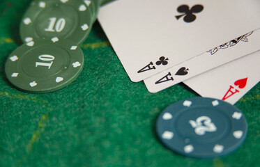 poker chips and cards on green background