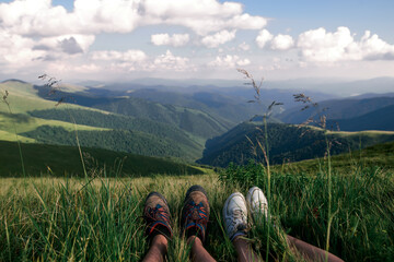Couple Tourists Feets resting on the Mountain Trail Hike Backpacking 