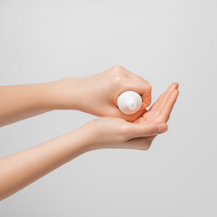 Women's hands squeeze the cream out of the tube to moisturize the hands.