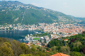 Fototapeta na wymiar Panoramic aerial view of the city of Como facing the famous Lake Como and the surrounding mountains