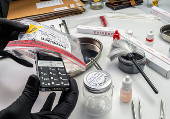 Forensic lab, forensic police take mobile from murder victim's evidence bag, conceptual image - obrazy, fototapety, plakaty