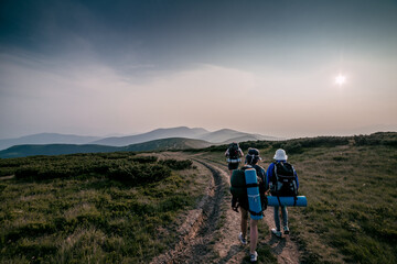 People Hiking Mountain Trail Path at Sunset