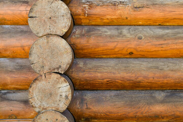 Texture of wall of house made of rounded logs. facade of log house, space for text. Wooden log wall built from smoothly polished logs. Construction of houses from natural materials. Wooden frame 