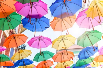 Obraz na płótnie Canvas umbrellas against a sunny sky. summer background
