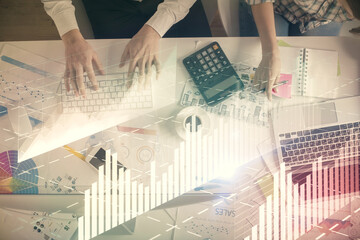 Double exposure of man and woman working together and financial chart hologram drawing. market analysis concept. Computer background. Top View.